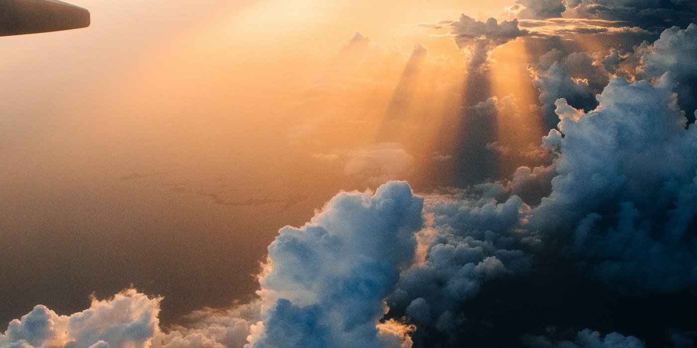View above the clouds from a plane window